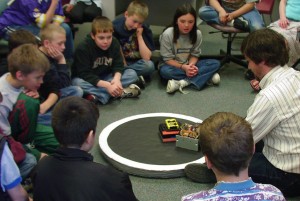 Rand Whillock demonstrates his sumo robots for students at a local school